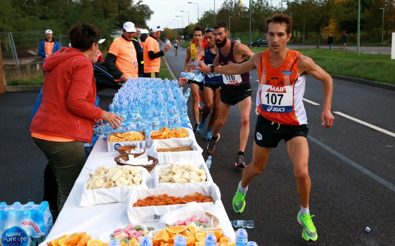 Runners consume food during a half marathon