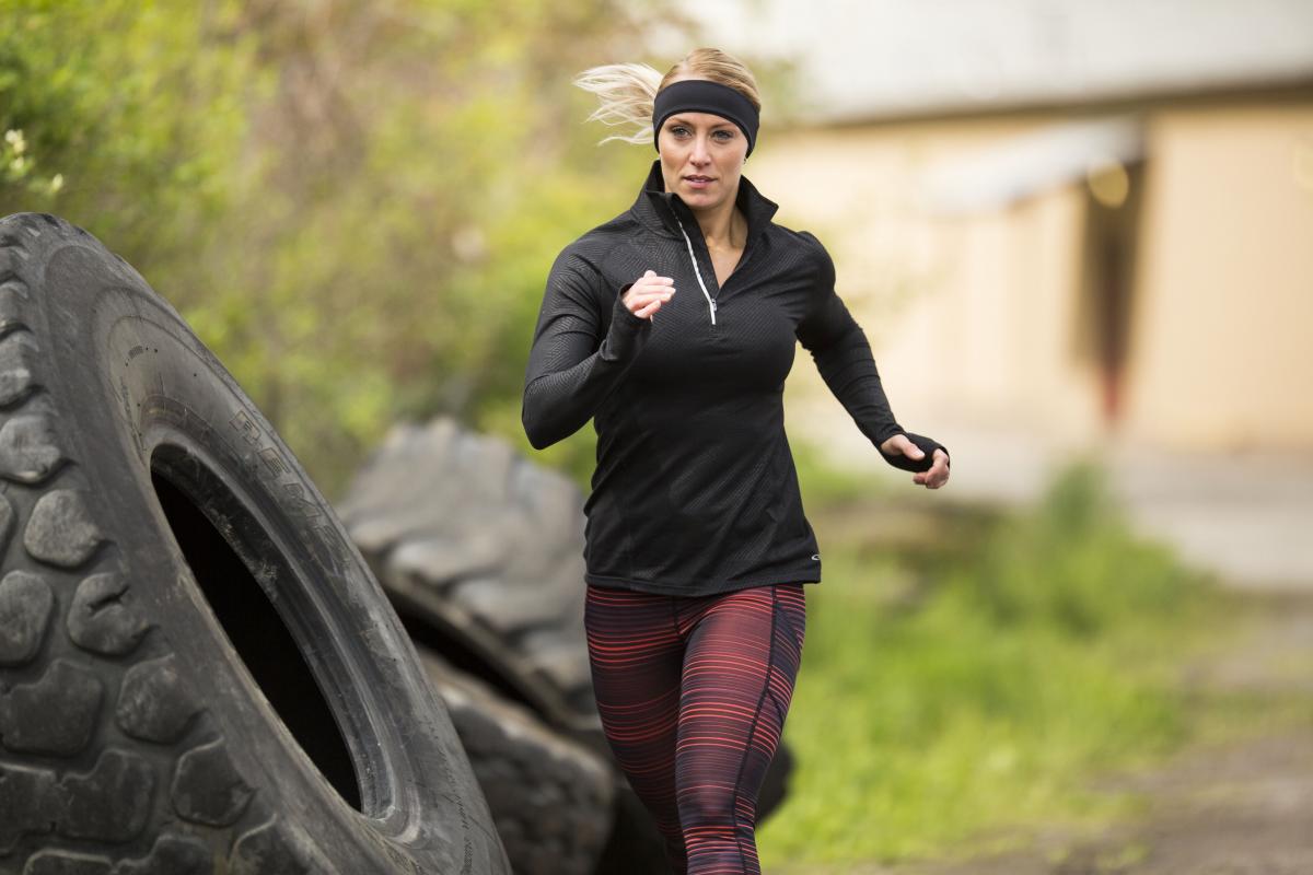 Running woman wear a headband for protection of ears in the cold season