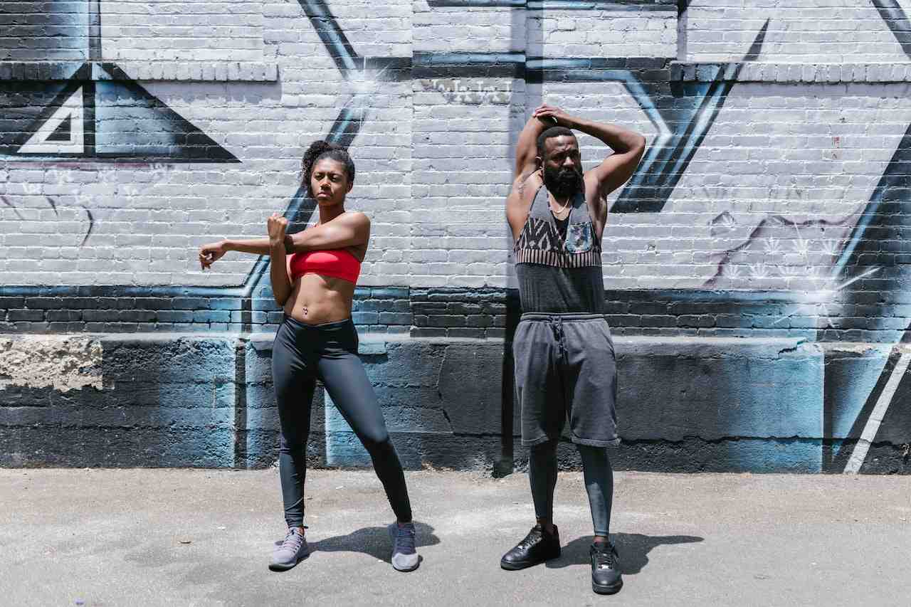 Man and woman training in running tank tops