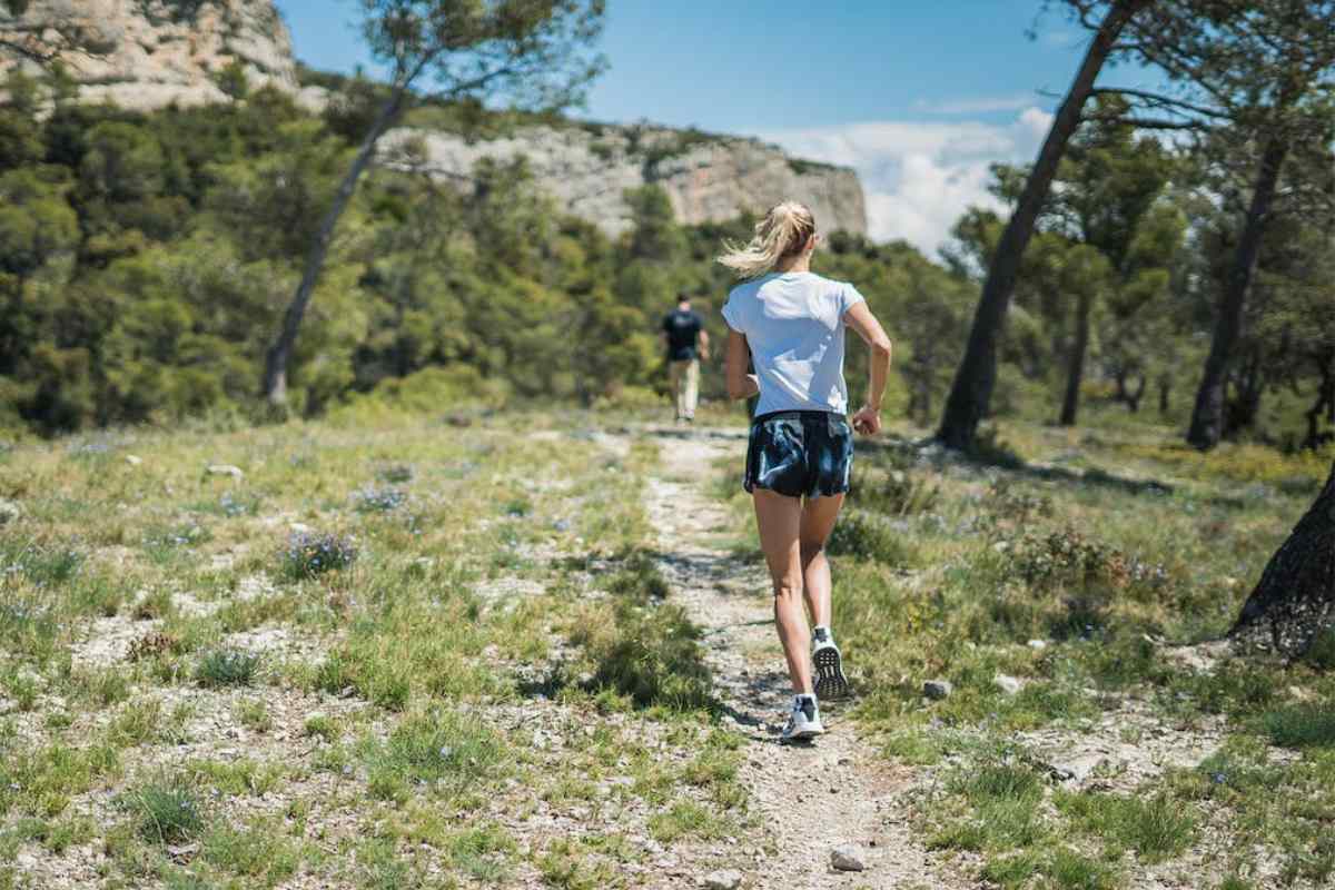 A female runner is seen training on hills