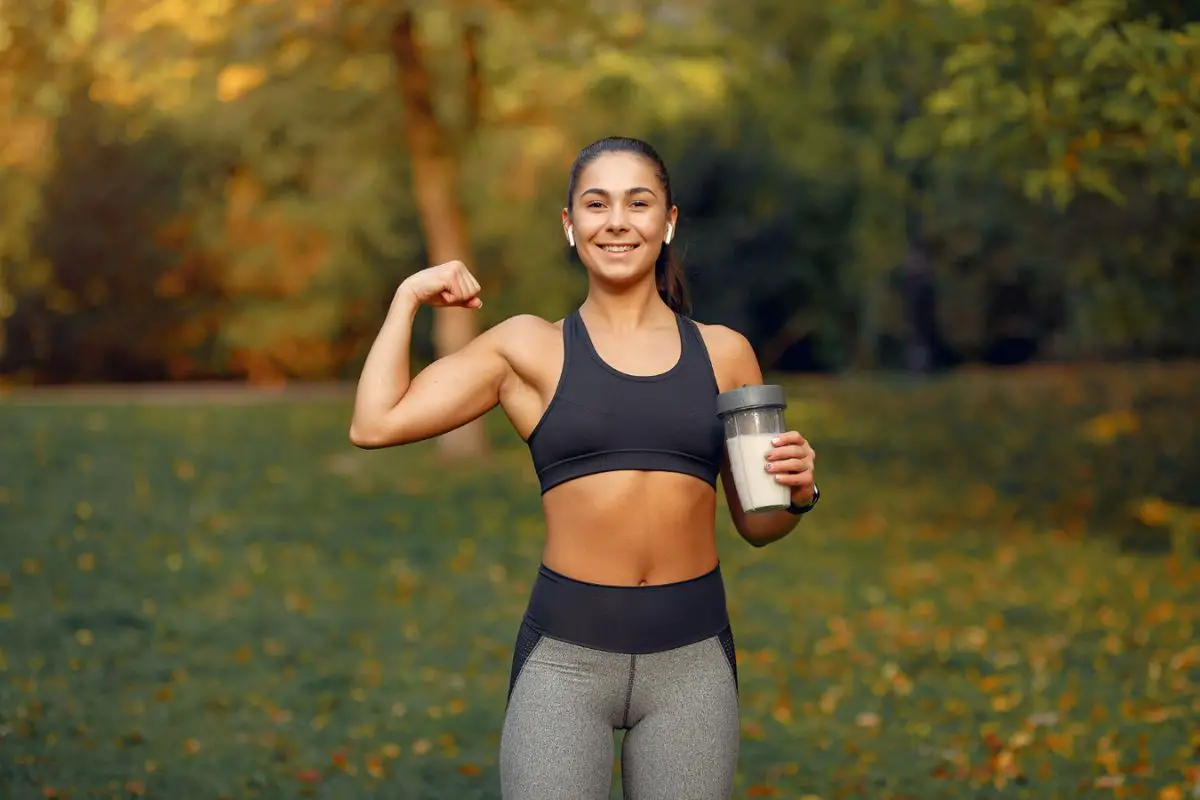 Woman drink protein shake to enhance muscle growth