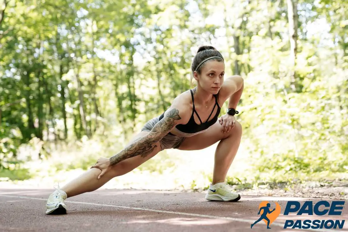 A female runner warms up with stretches before her run to prevent cramps while running 