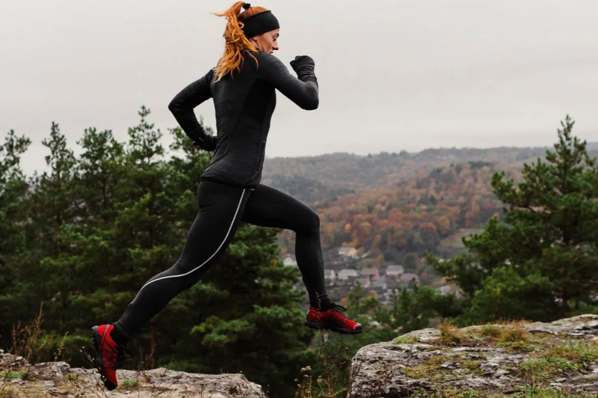 Female marathon runner practices her runs on trails and mountain routes