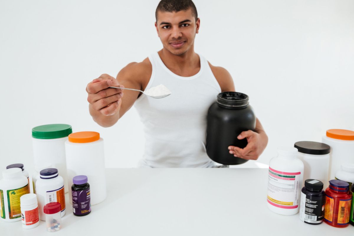Man showcases post-workout powder for recovery muscles