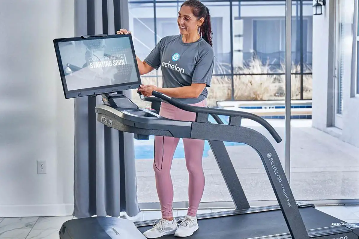 Woman demonstrating a treadmill with big screen