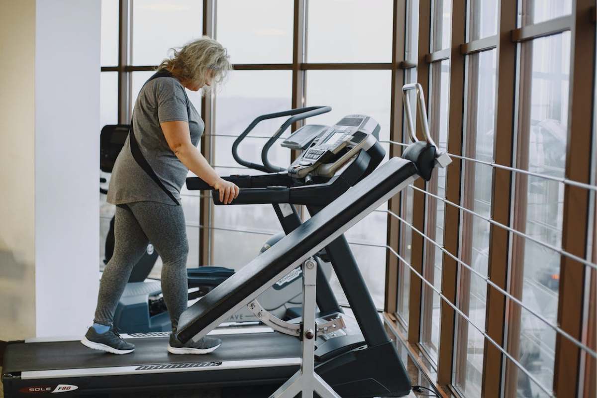 Woman running on an comfortable treadmill with advanced joint protection technology