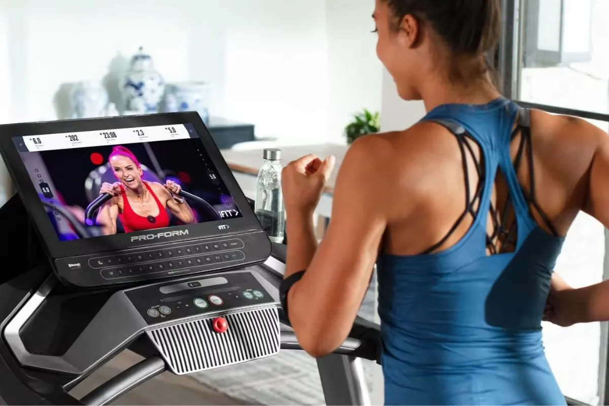 Woman running on a Netflix treadmill while watching a training program on screen