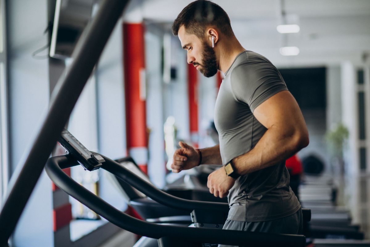 Man focused on muscles workout on the treadmill