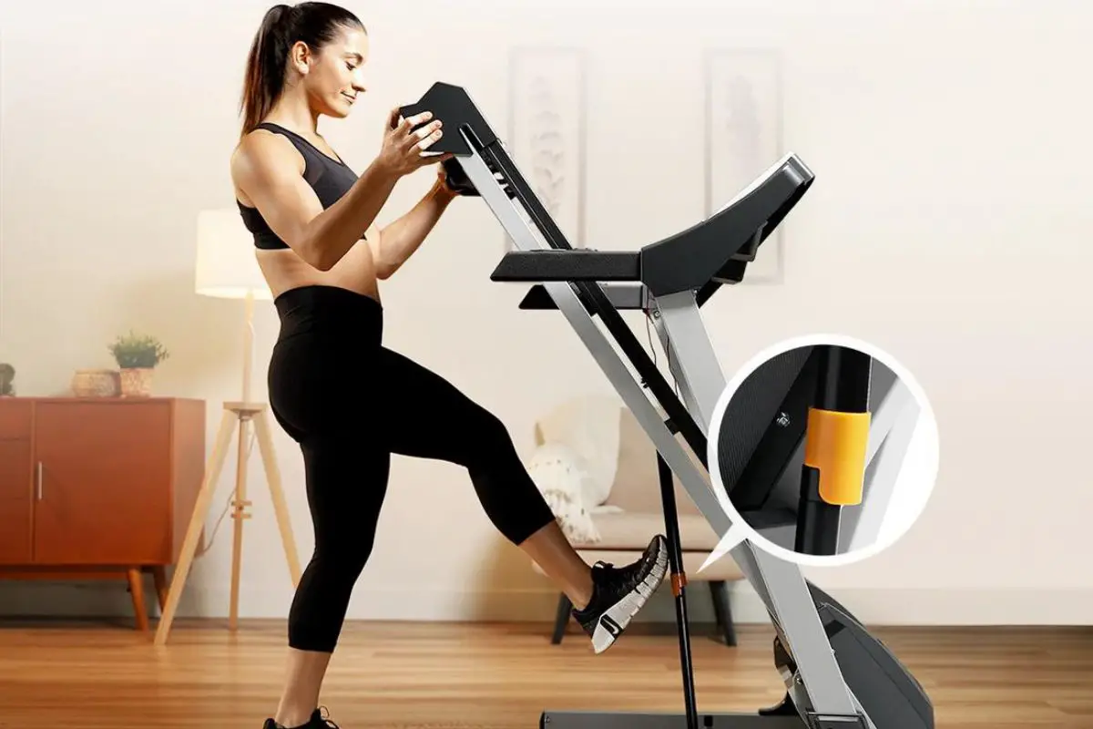 Woman using a foldable Sunny Health and Fitness Treadmill